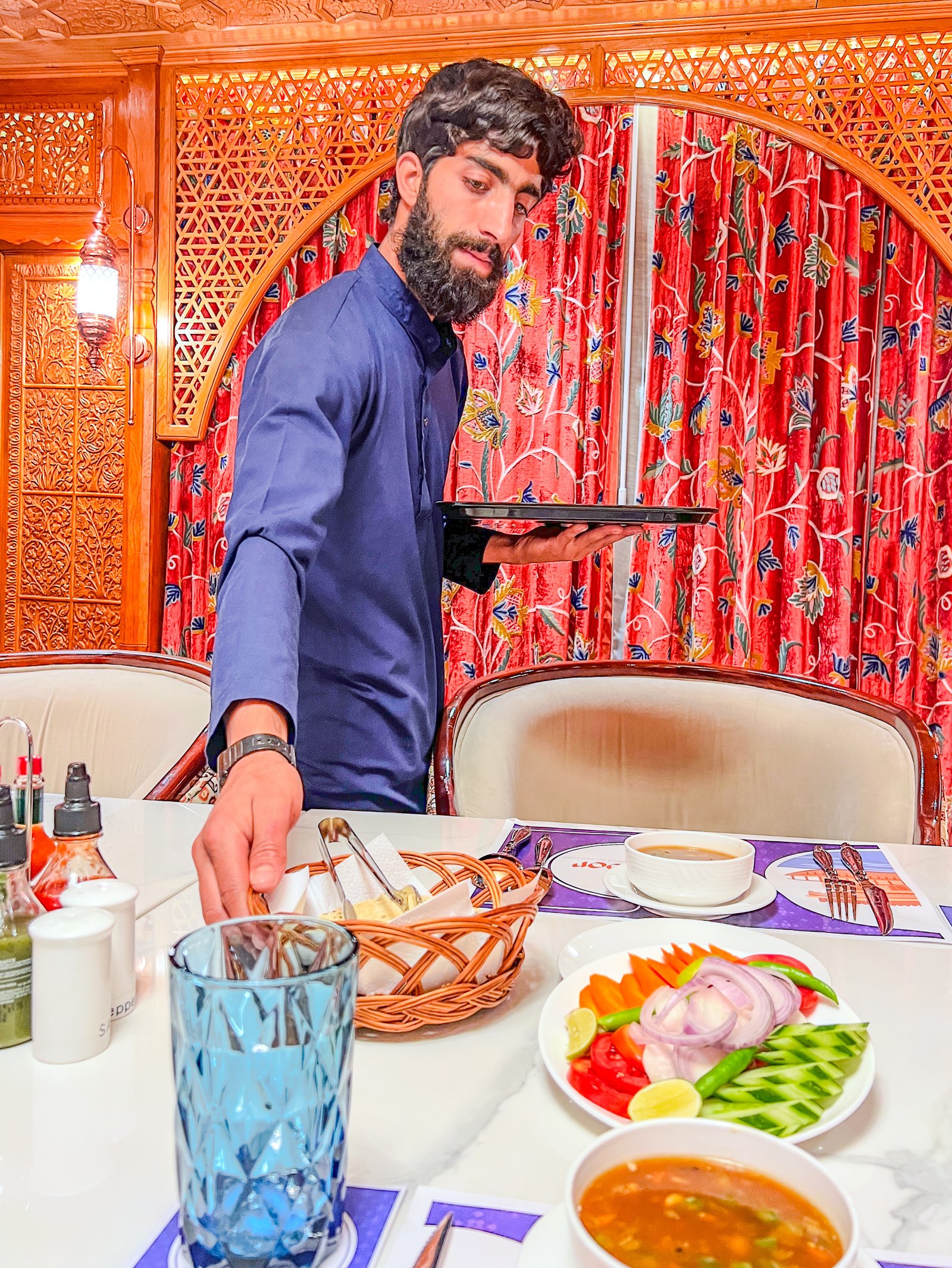 Staff serving fresh meal at Suroor luxury houseboat Srinagar